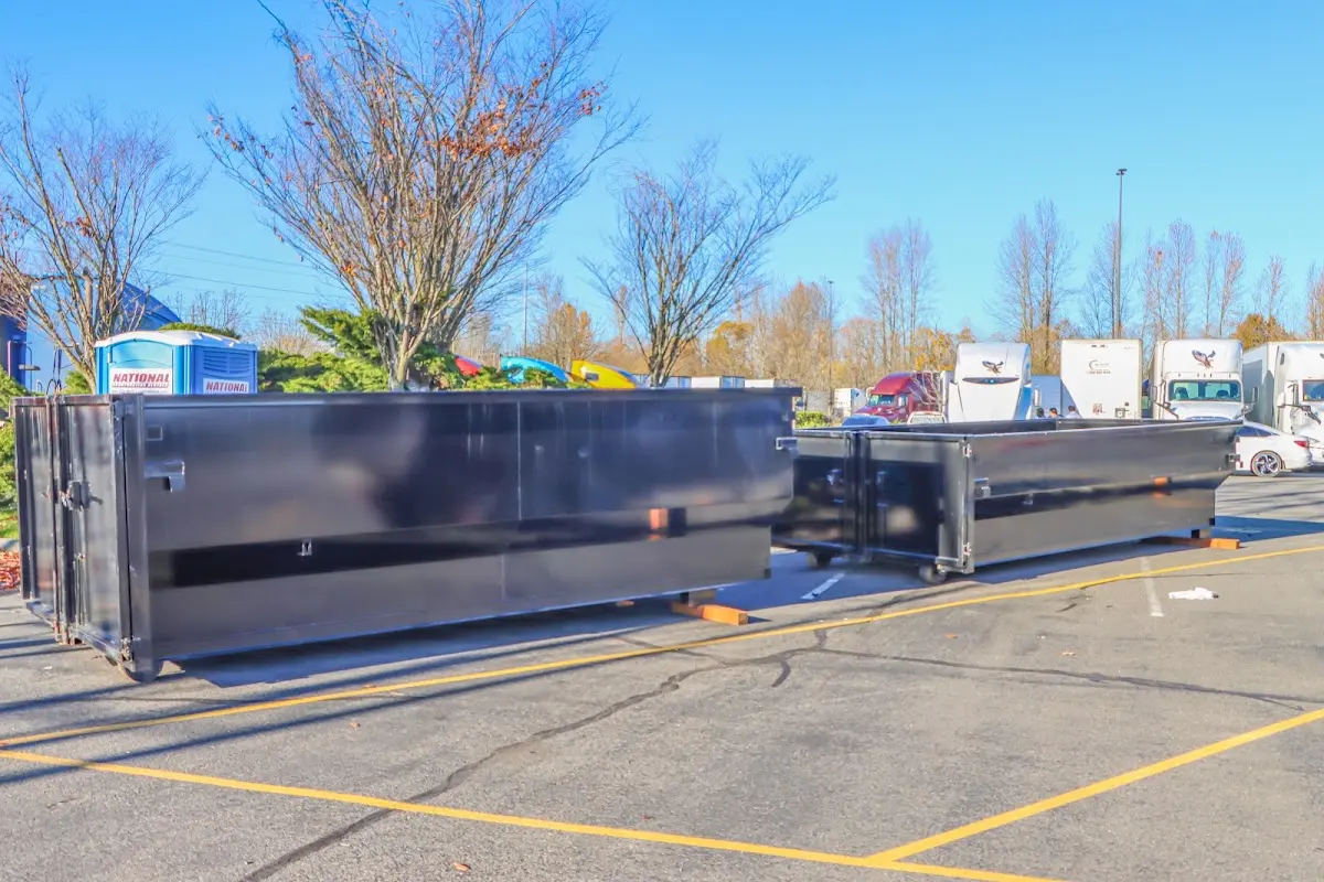 Professional dumpster rental service with roll-off container on residential driveway in Summit View